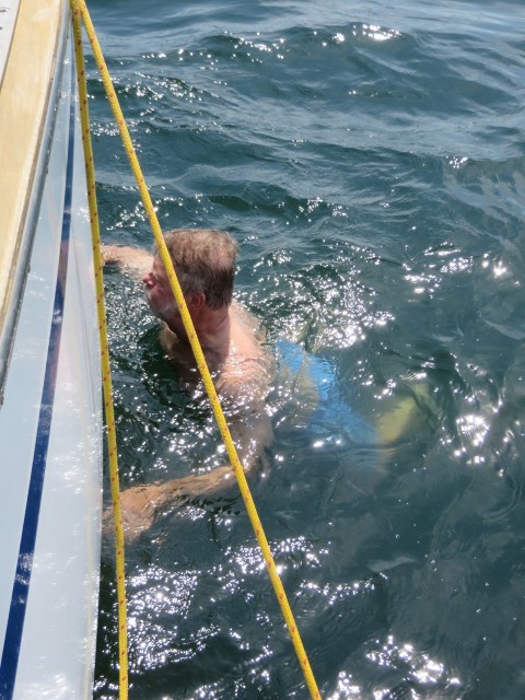 Al does his swimming while scrubbing the side of the boat