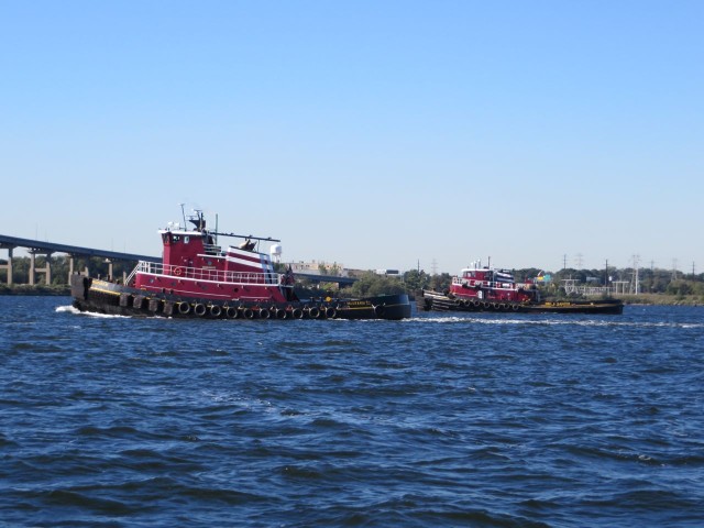 Twin tugs on their way to guide a big ship into the harbor