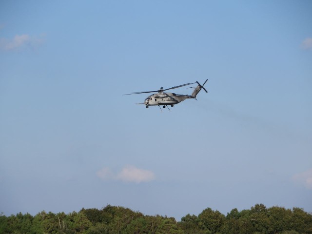 Helicopters take off, pass overhead, and land again over and over again 