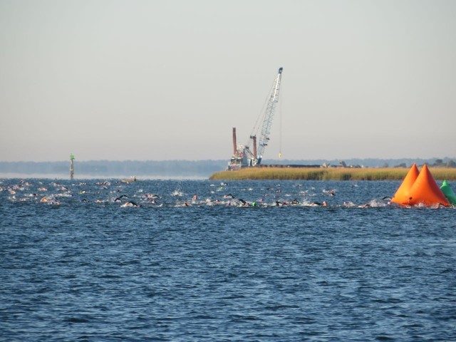 A mass of swimmers passing the buoy that marks the turn point