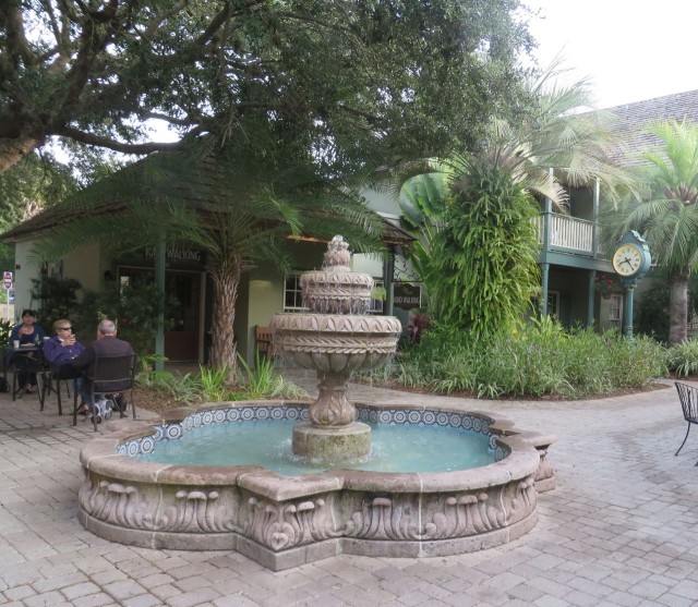 A little fountain among the shops and trees