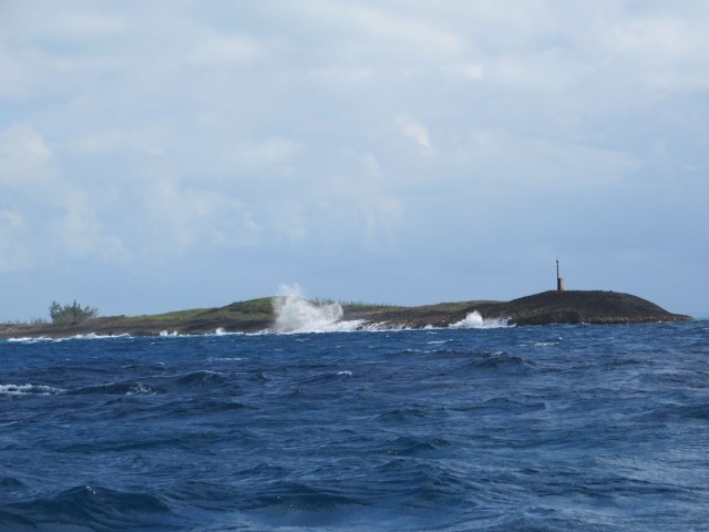 The ocean surf crashes against Whale Cay