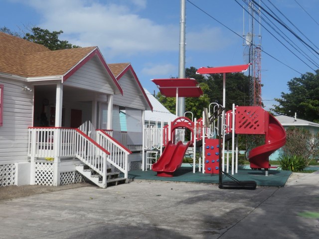 The small buildings, attached to each other by decks and stairs, stretch up the hill to the other higher road.