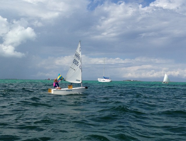 There were 3 children racing on Opti boats. This little girl was serious as she sailed by our dinghy.