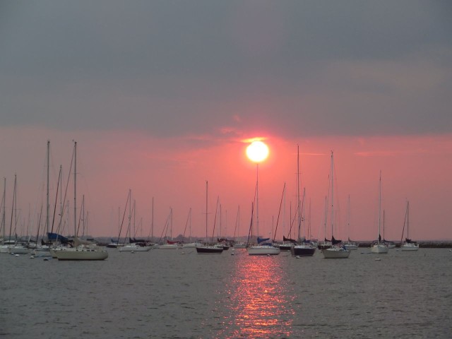 The sun set over the sailboats at Sandy Hook