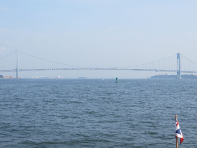 The Verranzano Narrows Bridge ahead appears in the distant haze.