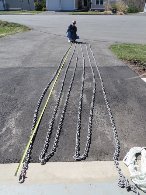 Stretching the chain out in the driveway to measure and mark it in 25 foot intervals.