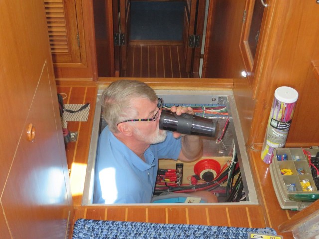 The Captain having his morning coffee while checking on the boat's systems.