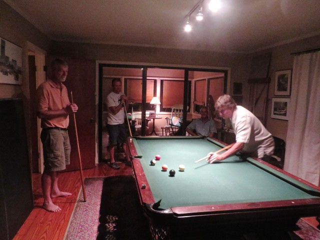 A game diverts the guys' conversations from boat talk to billiards.