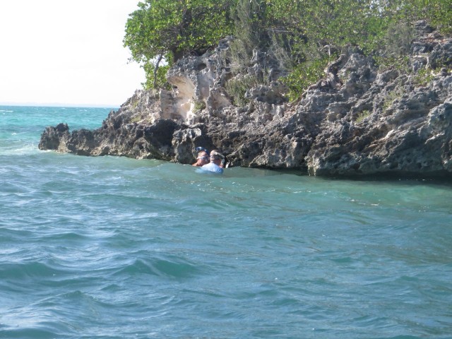 Dan and Al head over to search under the ledge of this tiny rocky cay.