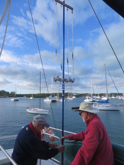 Paul and Al are attaching the race flag staff system to our flybridge. 