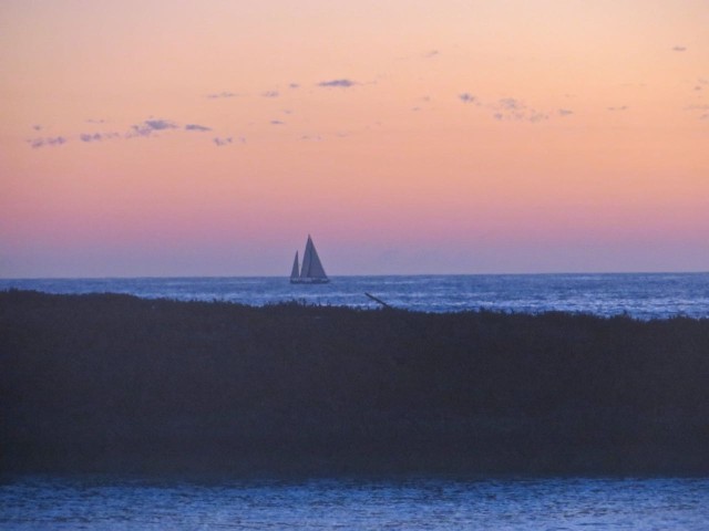 I got up before the sun arose to greet the dawn. Froth flybridge, I was high enough to photographed this sailboat passing Lynyard Cay on the Atlantic Ocean side.