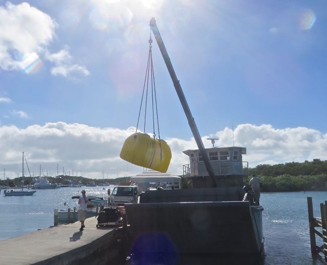 The crane lifts it off the boat and onto the dock, but that is as far as it goes.