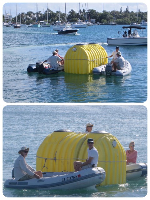 With a dinghy on each side of the tank, it wass guided out of the Hope Town harbor, and out to the outer harbor to John and Carol's lot.