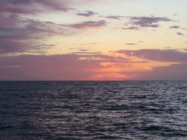 The pre-dawn light appears over the ocean as we exit the inlet.