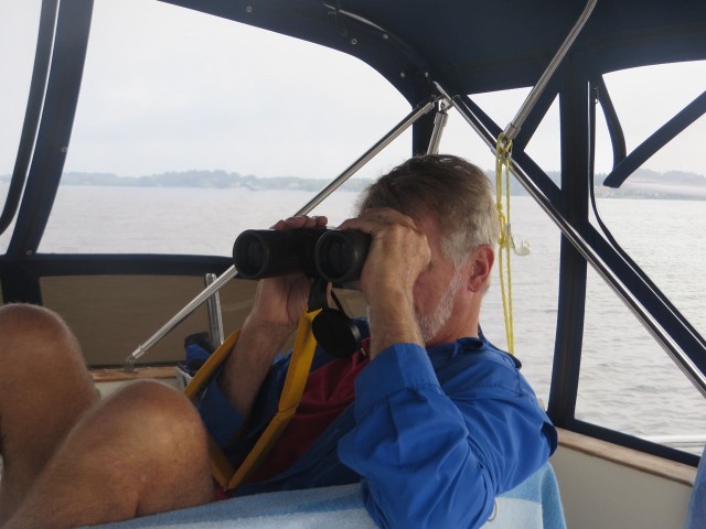 Al with binoculars checking out boat’s names, abandoned boats, and anything else that catches his eye.