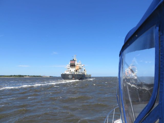 The barge passes us by. There can be heavy barge and container ship traffic on the Cape Fear. BTW, the sailboat recovered his dropped anchor after the barge passed him. 
